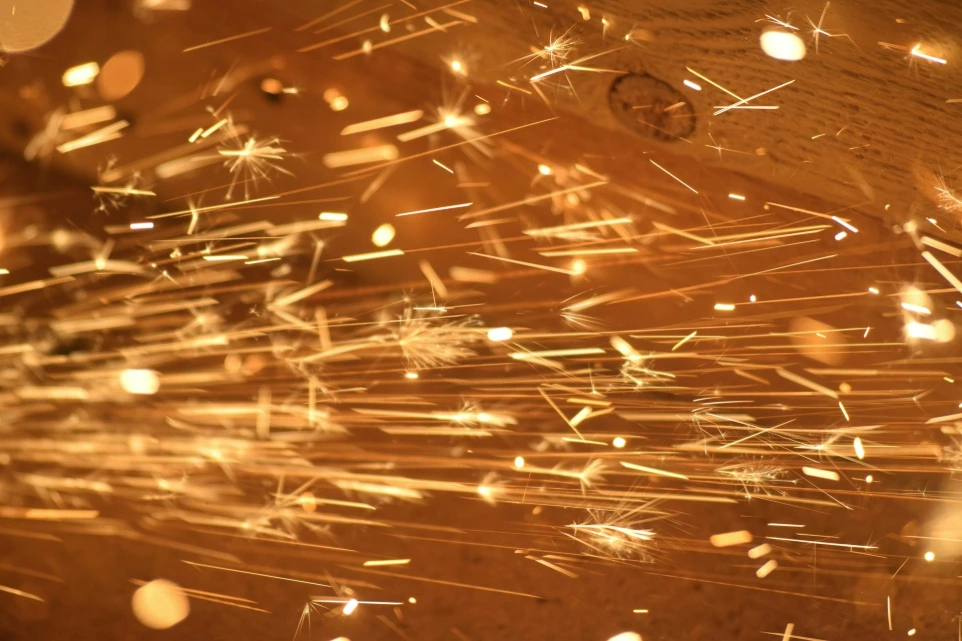 a close up of a clock on a wooden surface